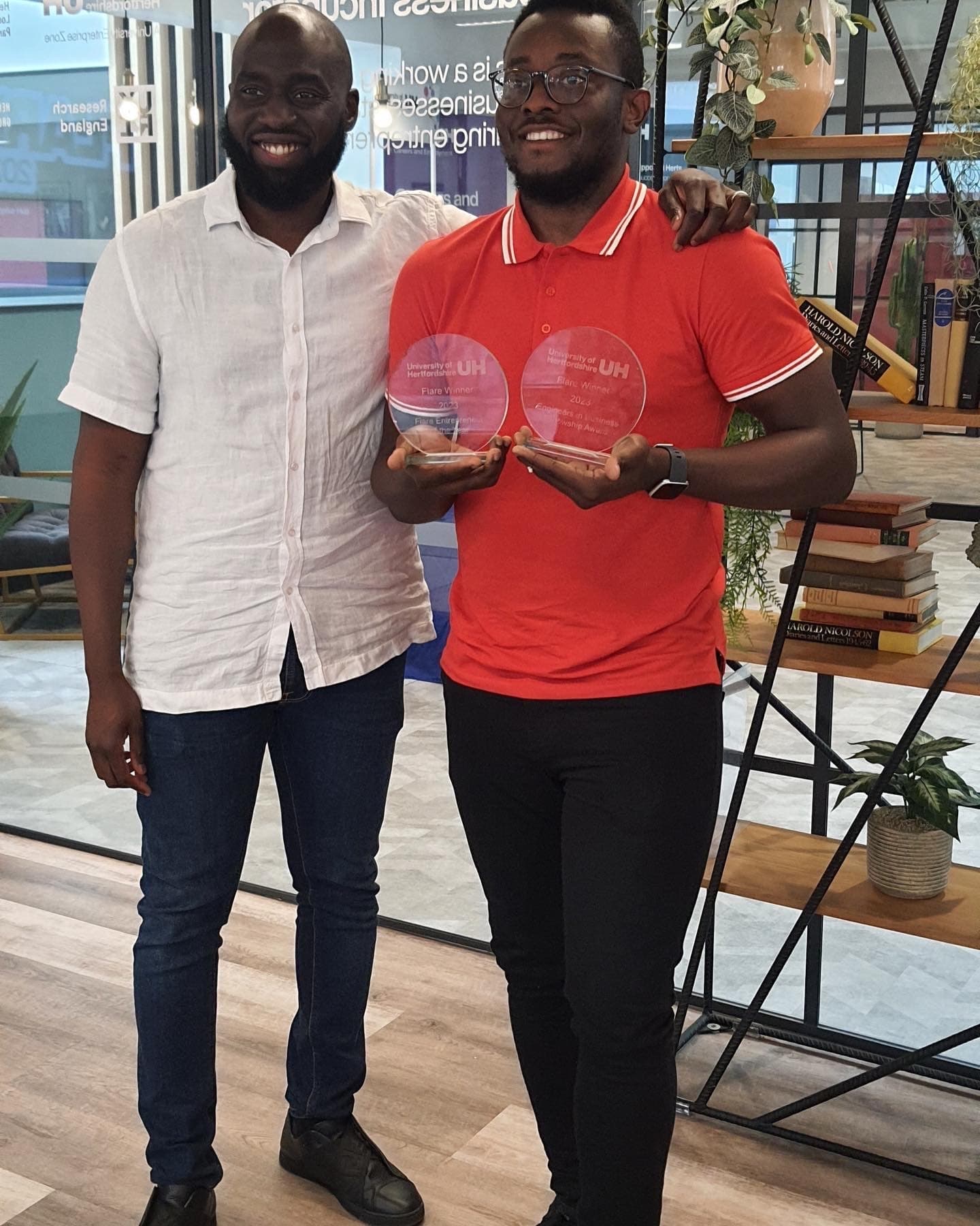 Fidelis with Raphael Sofoluke holding award trophies